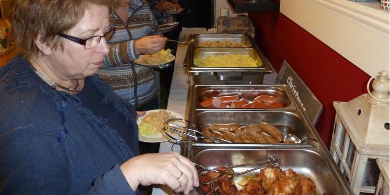 Bedrijfsuitje Friesland, een groep collegas die de kustlijn van friesland weergeven in een mooi mozaiek, met ronde en blauwe stenen, afsluitend met een stampot buffet.